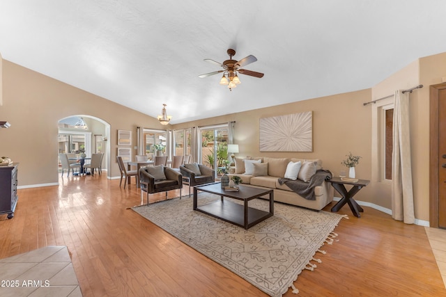 5822 W Abraham Ln, Glendale, AZ 85308 - living room featuring ceiling fan, light wood-style flooring, arched walkways, and vaulted ceiling