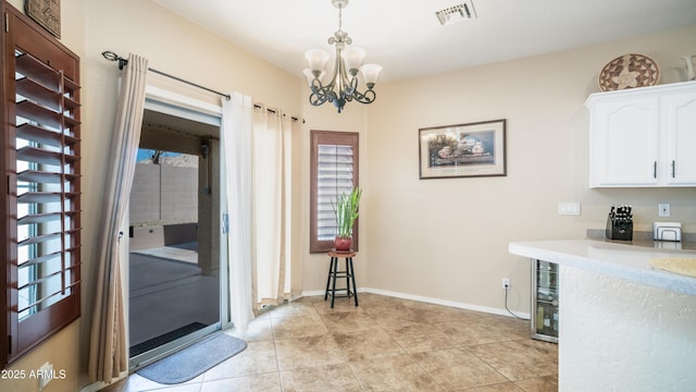 interior space featuring wine cooler, light tile patterned flooring, a notable chandelier, visible vents, and baseboards