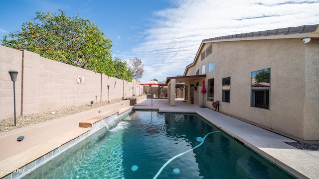 view of swimming pool featuring a fenced backyard, a fenced in pool, and a patio