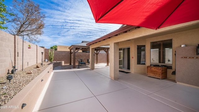 view of patio / terrace featuring a fenced backyard and a gazebo