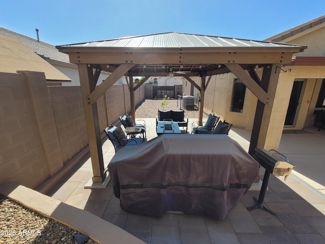 view of patio with a gazebo, a fenced backyard, and an outdoor living space