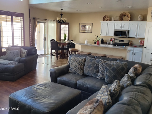 living room with a chandelier, visible vents, and light wood-style floors