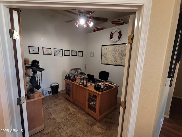 office featuring dark tile patterned floors and a ceiling fan