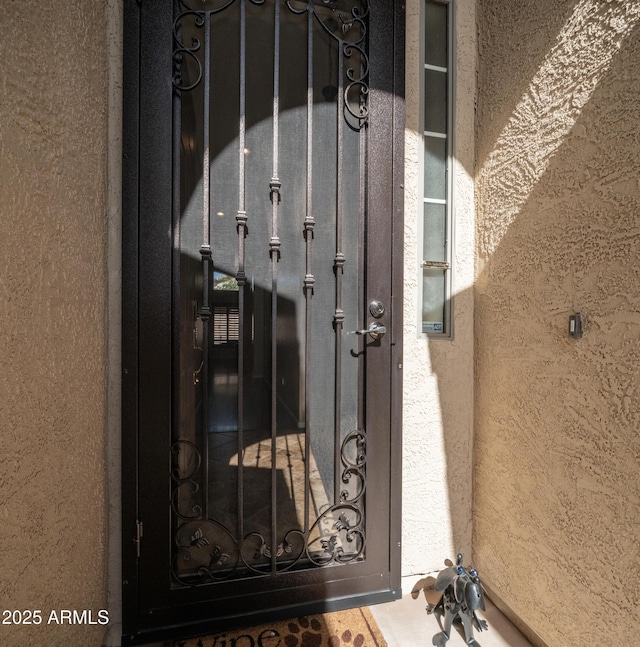 view of exterior entry with stucco siding