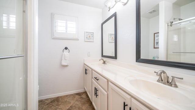 bathroom with a healthy amount of sunlight, double vanity, and a sink