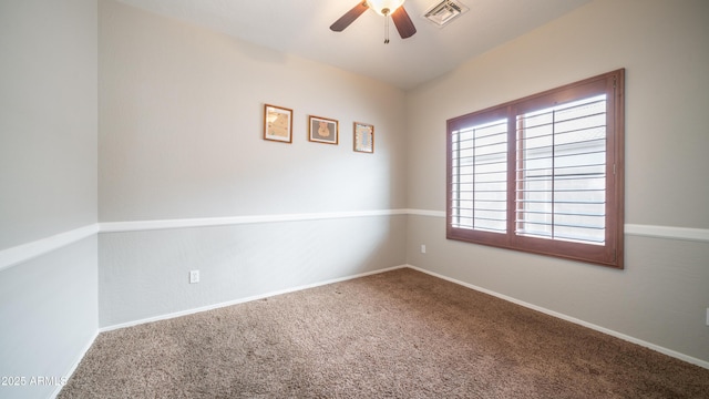 empty room featuring a ceiling fan, baseboards, visible vents, and carpet flooring