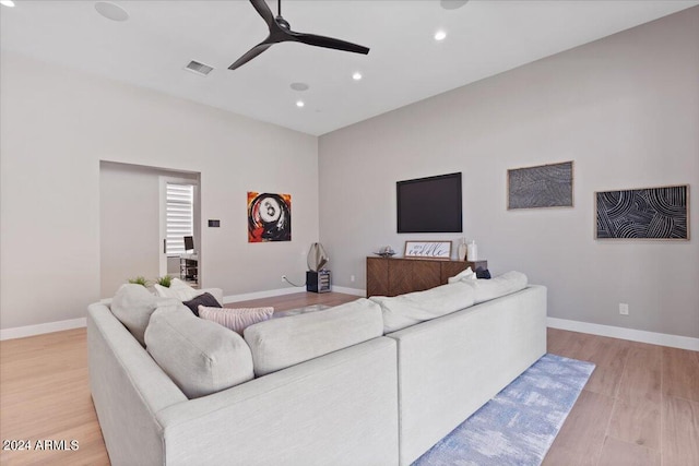 living room with light wood-type flooring and ceiling fan