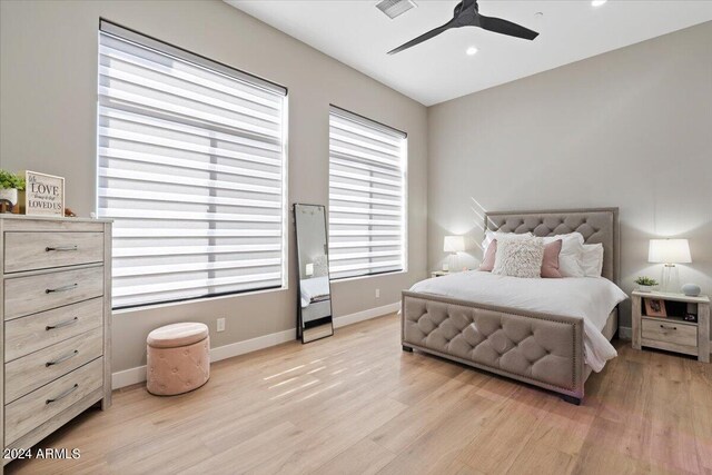 bedroom with light hardwood / wood-style floors and ceiling fan