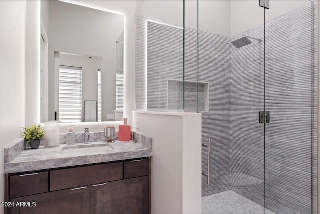 bathroom with vanity and a shower with shower door