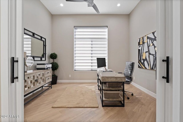 office featuring light hardwood / wood-style floors and ceiling fan