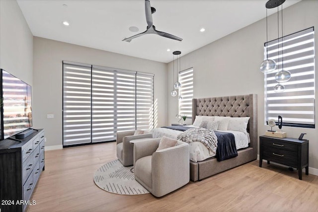 bedroom with light wood-type flooring and ceiling fan