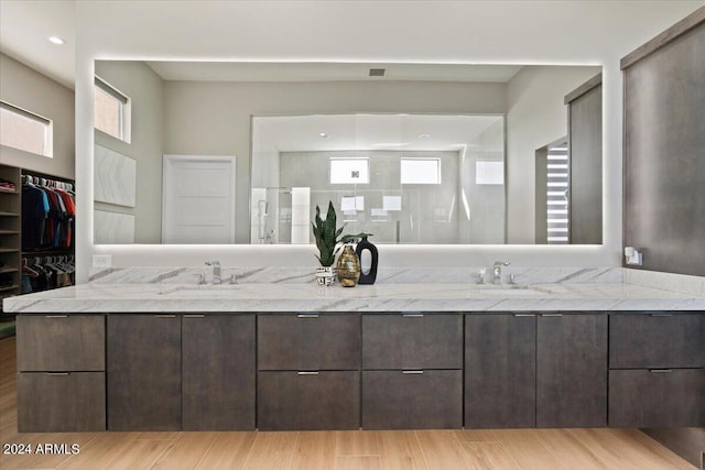 bathroom featuring vanity, hardwood / wood-style flooring, and a shower