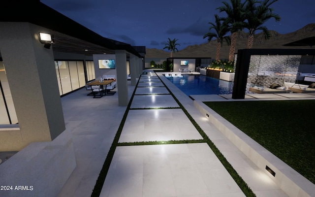 pool at twilight with a patio area