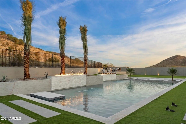 view of pool with pool water feature and a mountain view