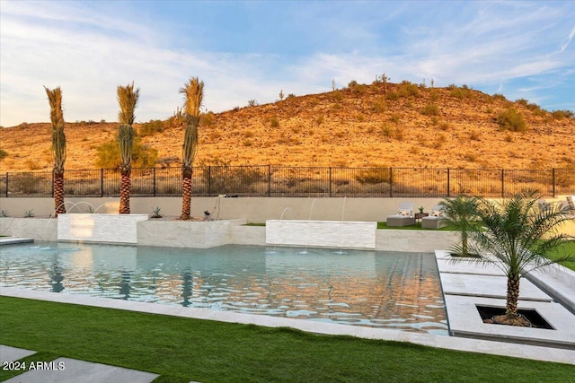 view of swimming pool featuring pool water feature and a patio area