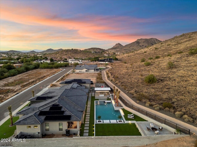 pool at dusk with a gazebo and a mountain view