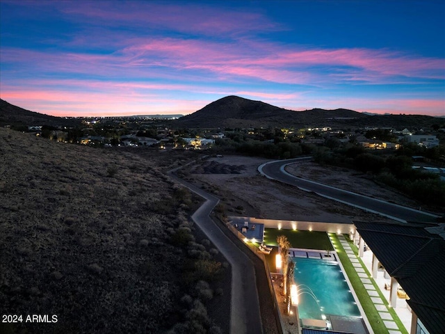 aerial view at dusk featuring a mountain view