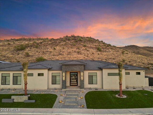 prairie-style home with a mountain view and a yard