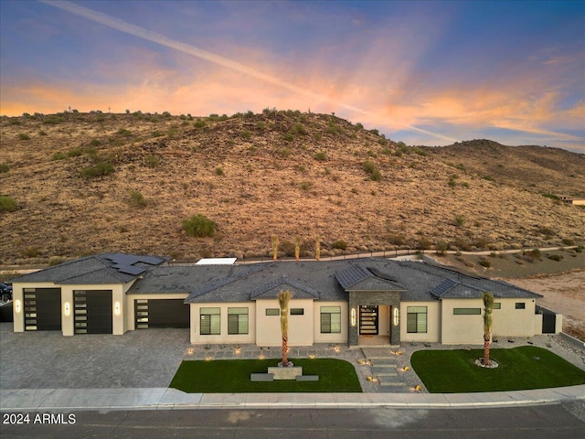 view of front of home with a mountain view and a garage