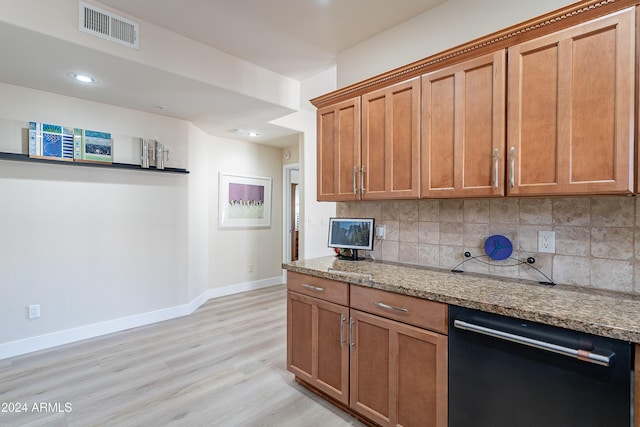 kitchen with tasteful backsplash, light stone counters, dishwasher, and light wood-type flooring