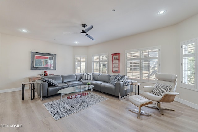 living room with ceiling fan and light hardwood / wood-style flooring