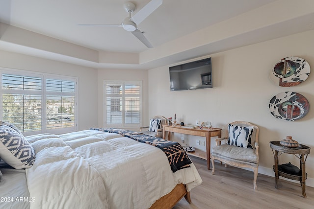 bedroom with ceiling fan and light wood-type flooring