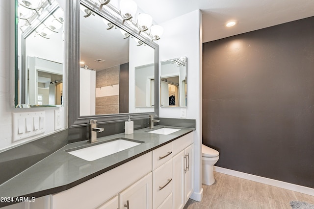 bathroom with hardwood / wood-style floors, vanity, and toilet