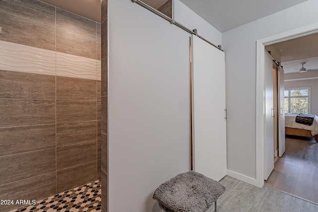 bathroom featuring hardwood / wood-style floors and tiled shower