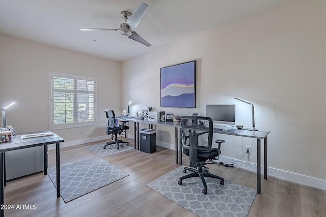 office featuring light hardwood / wood-style floors and ceiling fan