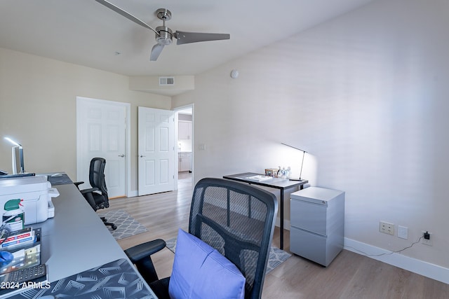 office area with light hardwood / wood-style flooring and ceiling fan