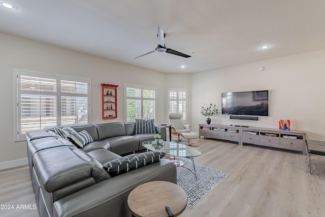 living room with light hardwood / wood-style floors and ceiling fan