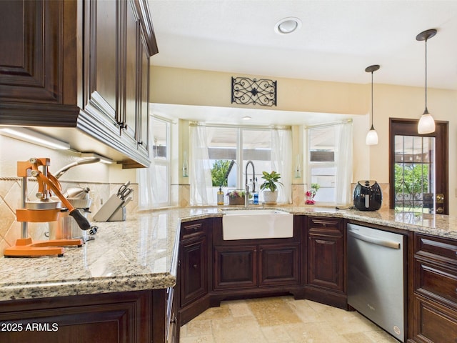 kitchen with stainless steel dishwasher, a sink, light stone counters, dark brown cabinets, and recessed lighting