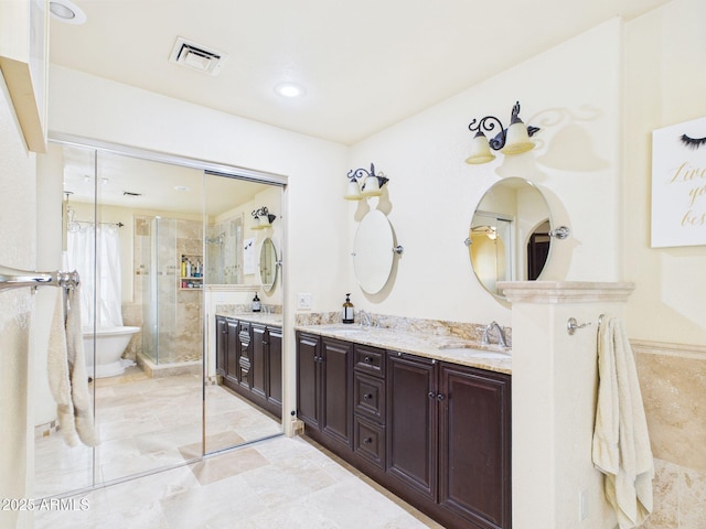 full bath with a stall shower, double vanity, a freestanding tub, and recessed lighting