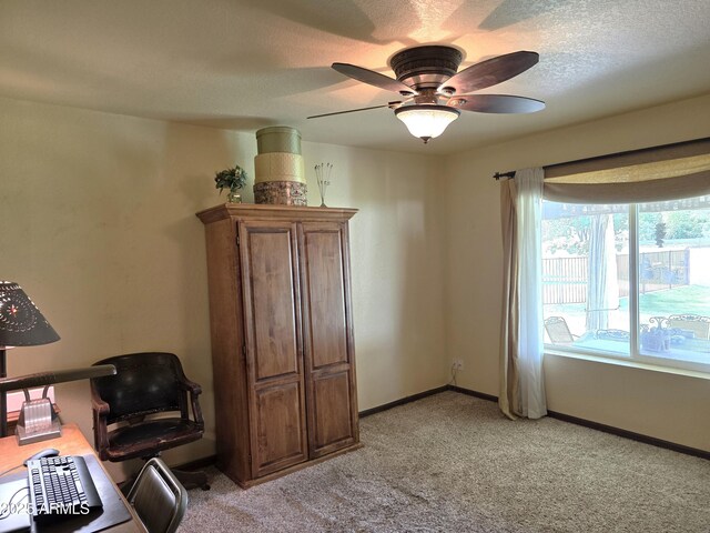 living area with light carpet, ceiling fan, and baseboards