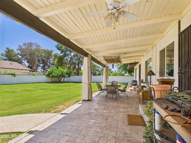 view of patio with outdoor dining area and a ceiling fan