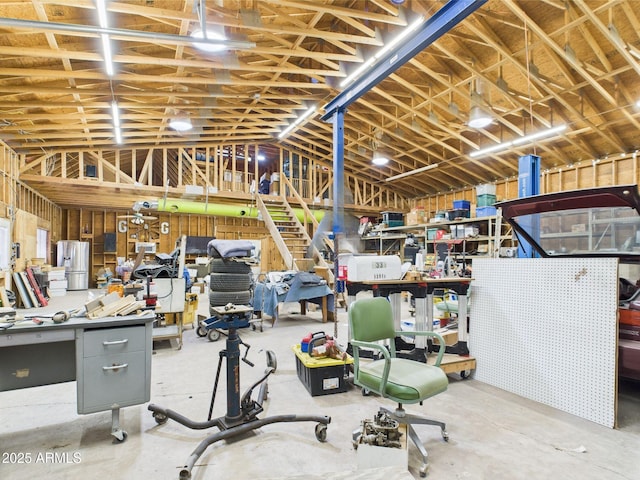 miscellaneous room featuring unfinished concrete flooring and vaulted ceiling
