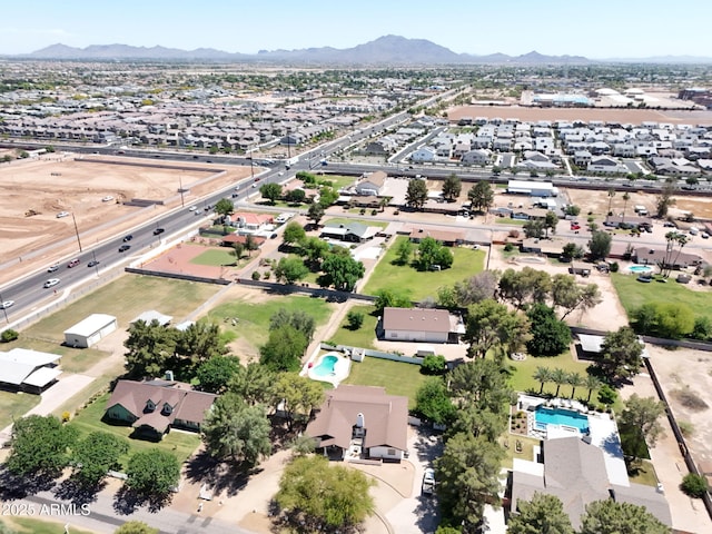 aerial view of residential area with a mountain backdrop and a pool