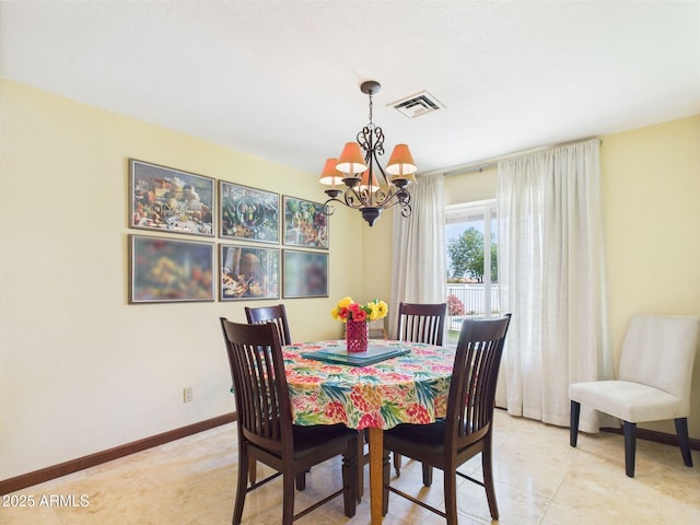 dining area featuring a chandelier, baseboards, and light tile patterned floors