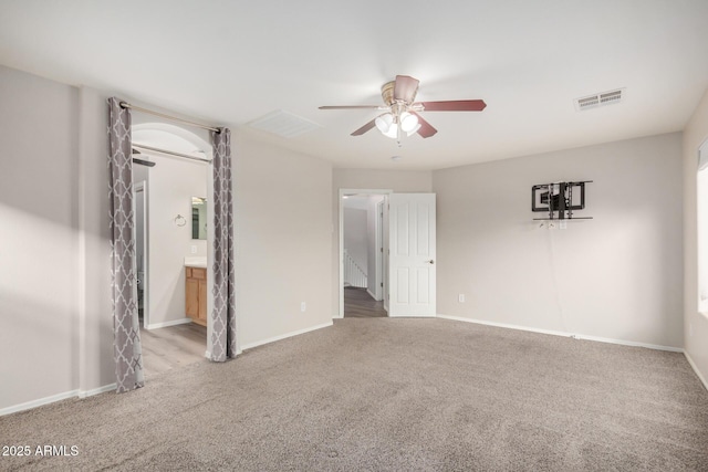 interior space featuring visible vents, baseboards, ceiling fan, and carpet flooring