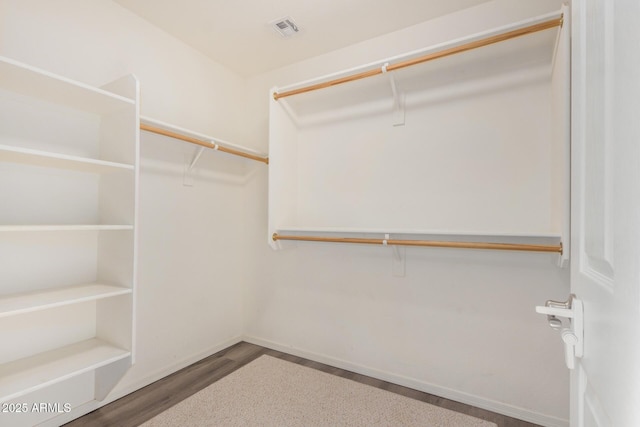 spacious closet with visible vents and wood finished floors