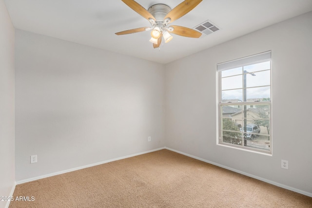 spare room with visible vents, baseboards, ceiling fan, and carpet flooring