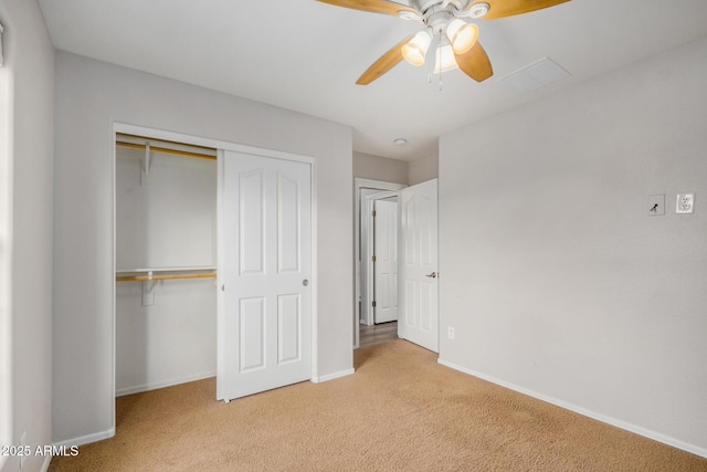 unfurnished bedroom with a closet, baseboards, carpet, and ceiling fan