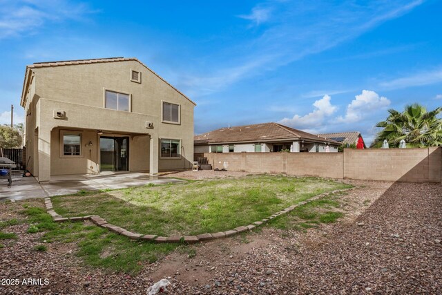 back of property with a patio area, a fenced backyard, and stucco siding