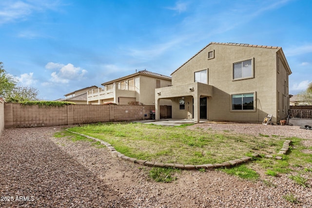 back of property with a patio area, a fenced backyard, and stucco siding