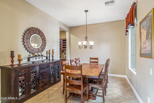 dining area featuring a chandelier, light tile patterned floors, visible vents, and baseboards