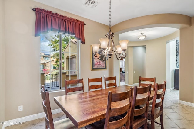 dining area with light tile patterned floors, plenty of natural light, visible vents, and arched walkways