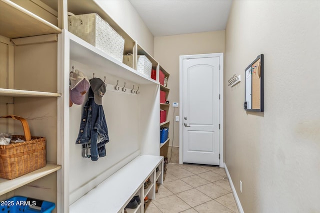 mudroom with light tile patterned floors and baseboards