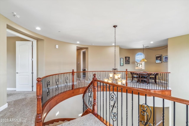 hallway featuring carpet floors, recessed lighting, baseboards, and an upstairs landing