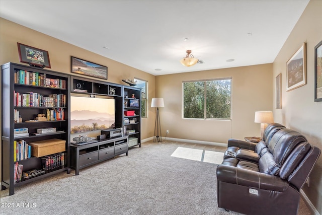 carpeted living room with baseboards