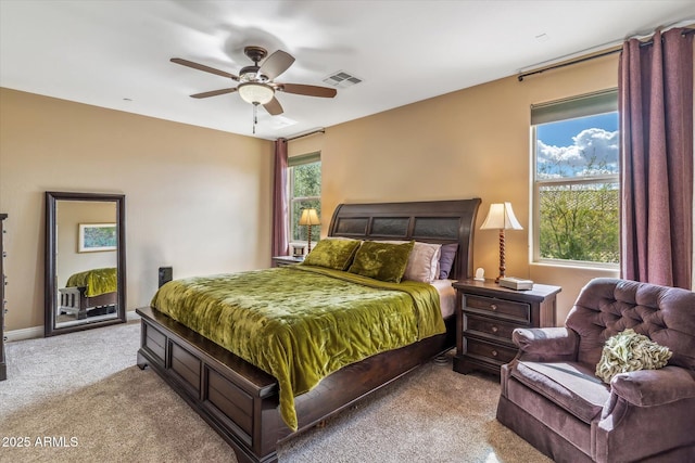 carpeted bedroom with ceiling fan and visible vents